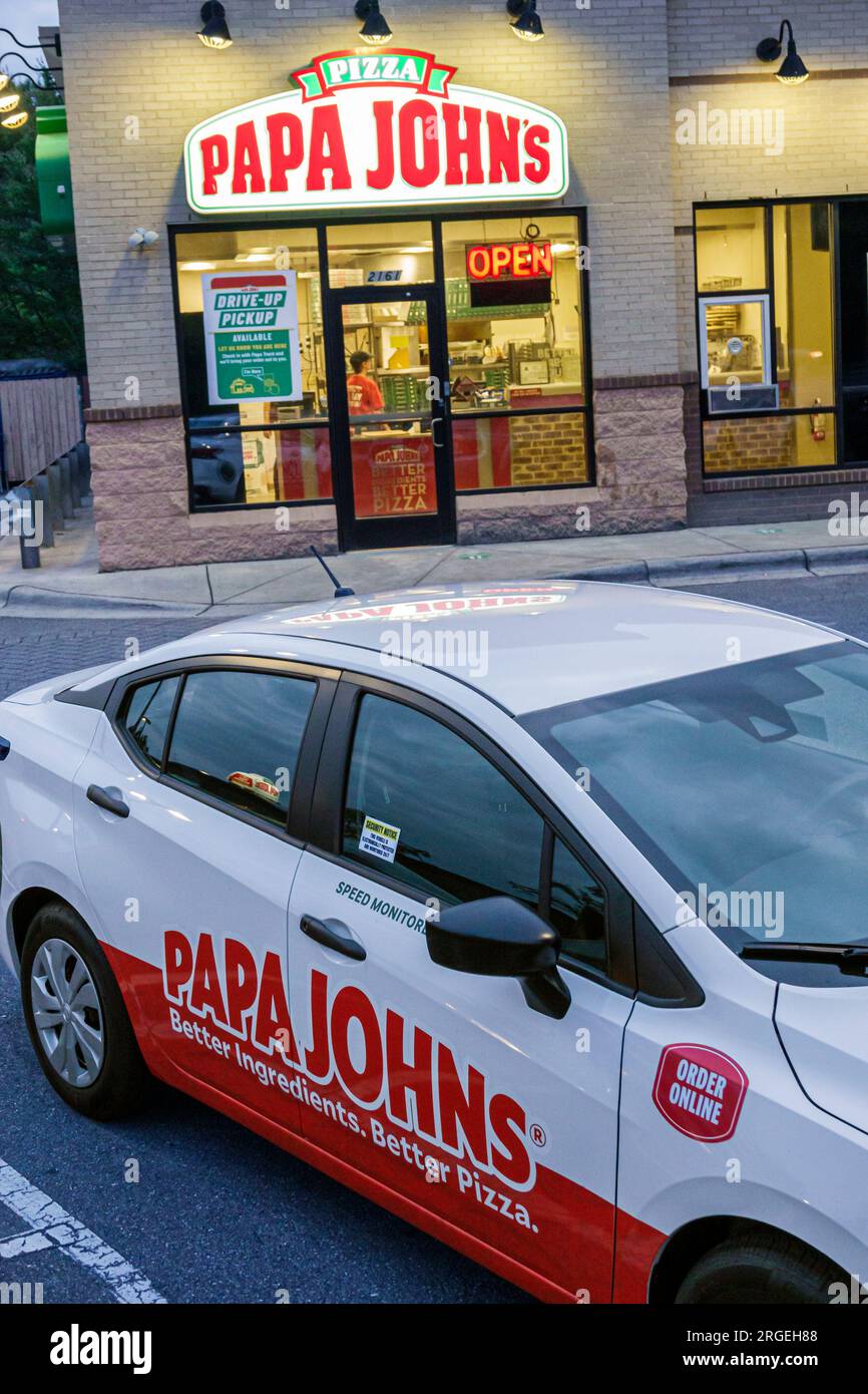Gastonia North Carolina,Papa John's pizza,evening night,company delivery vehicle car,outside exterior,building front entrance,restaurant dine dining e Stock Photo