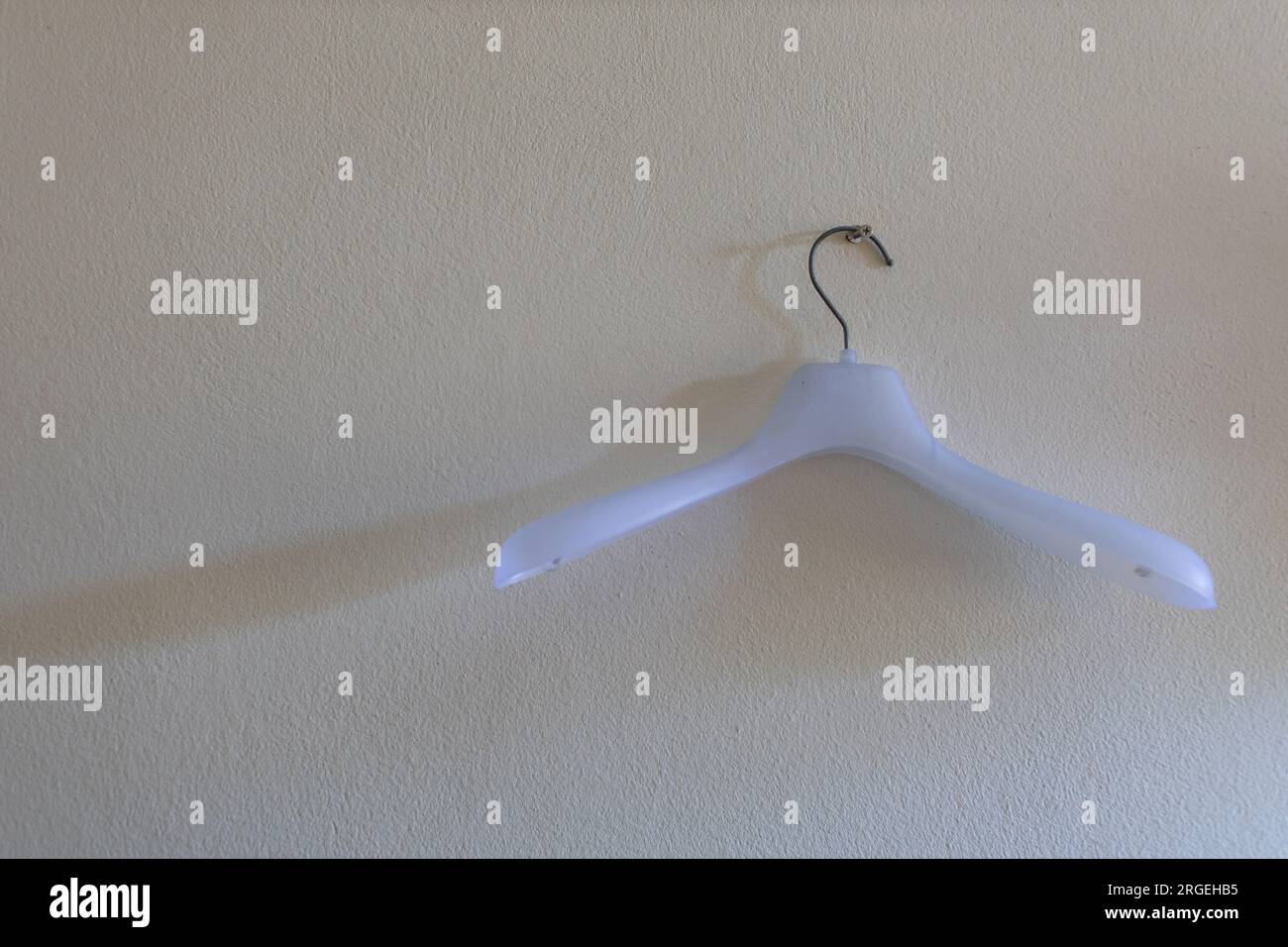 white plastic hangers on a white background Stock Photo