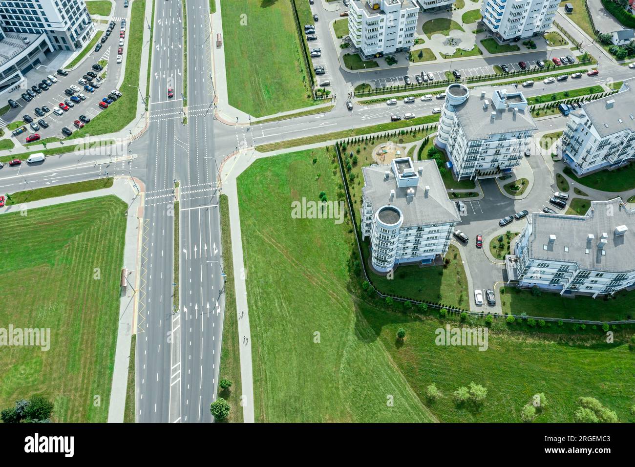 urban landscape with roads intersection. aerial view from flying drone at sunny summer morning. Stock Photo