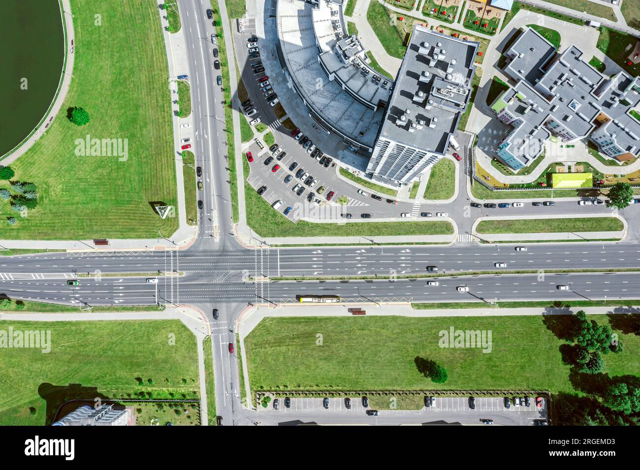 aerial drone view of streets intersection with car traffic in modern city at summer time. Stock Photo