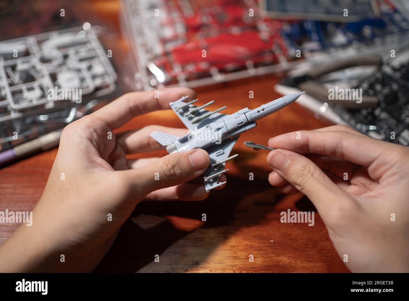 Assembling jet plane plastic model kit Stock Photo