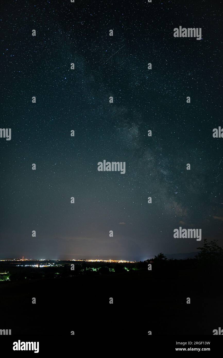 Beautiful image of the Milky Way galaxy rising over the city of Poprad in Slovakia. Stock Photo