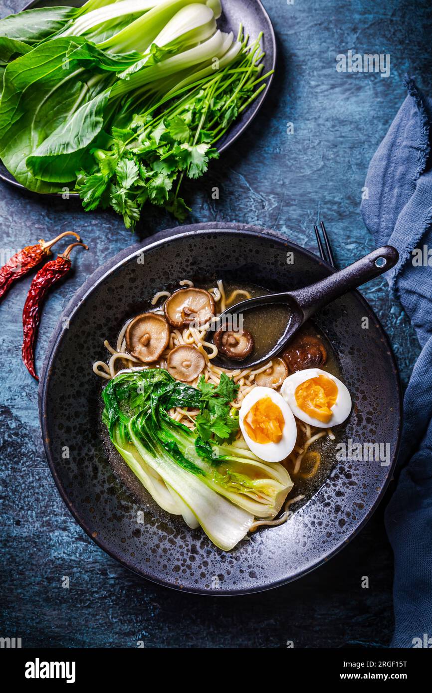 Miso ramen Asian noodles soup with shiitake, egg and pak choi cabbage