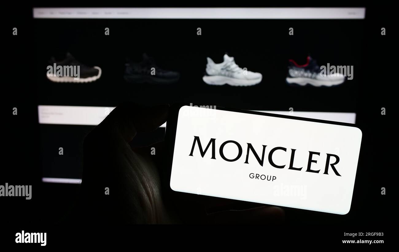Person holding smartphone with logo of Italian fashion company Moncler ...