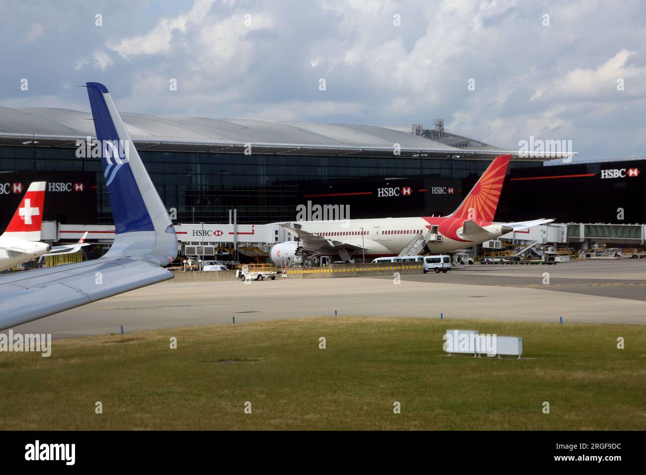 Aeroplanes on Tarmac outside Terminal Two Heathrow Airport London England Stock Photo