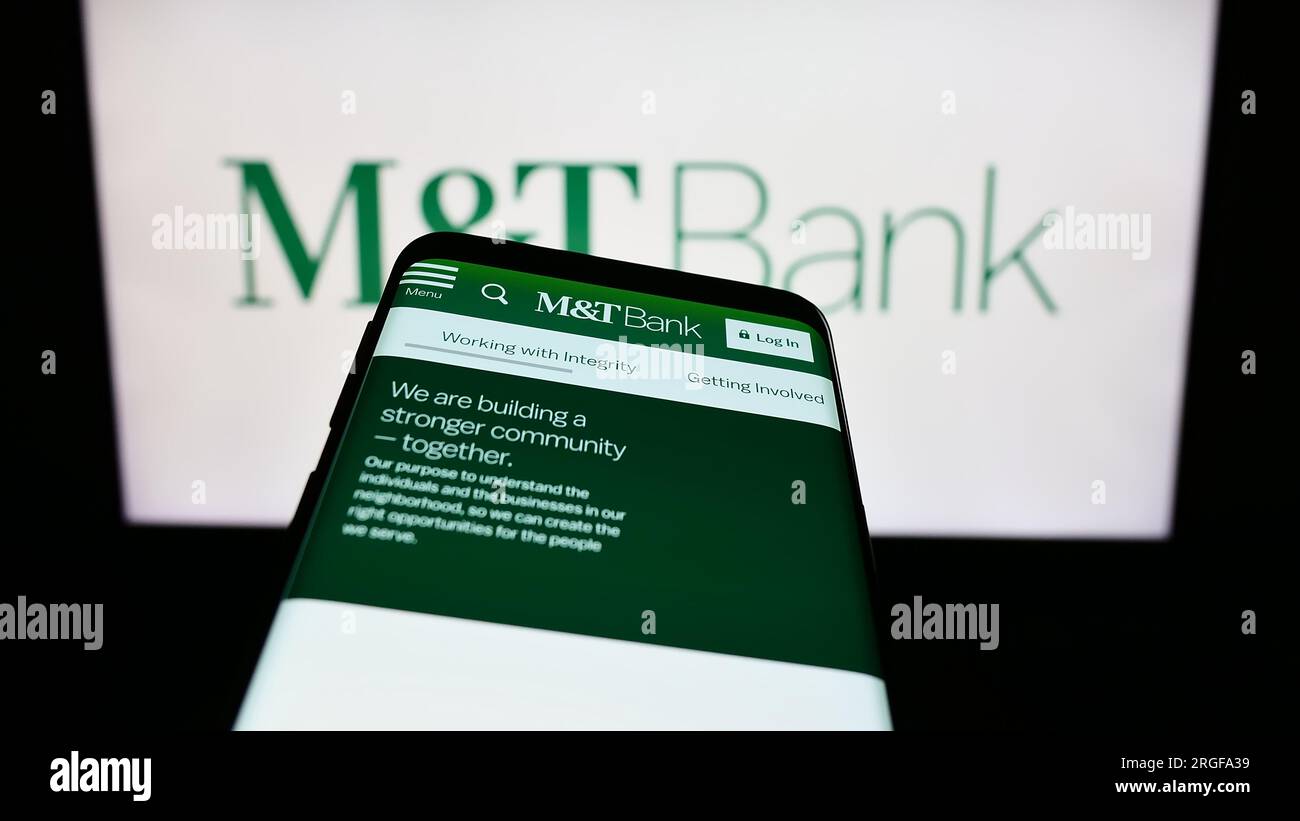 Smartphone with webpage of US financial company MT Bank Corporation on screen in front of business logo. Focus on top-left of phone display. Stock Photo