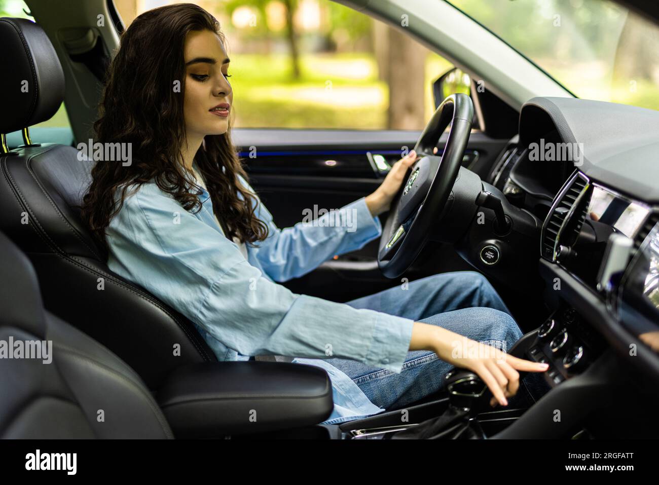 Exhausted young woman suffering from heat inside car with broken air