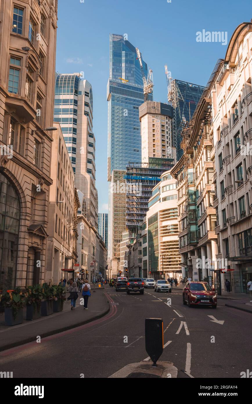 Cars moving on road by 22 tower amidst buildings in city Stock Photo Alamy
