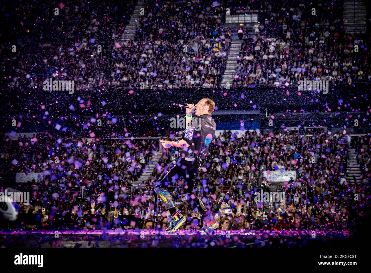 Coldplay band members performing live in **2023**