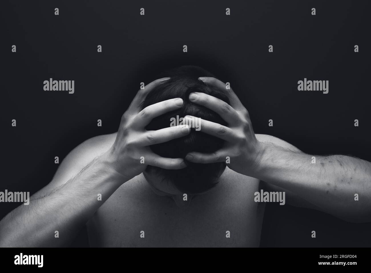 Man holding his head due to anxiety or depression Stock Photo - Alamy