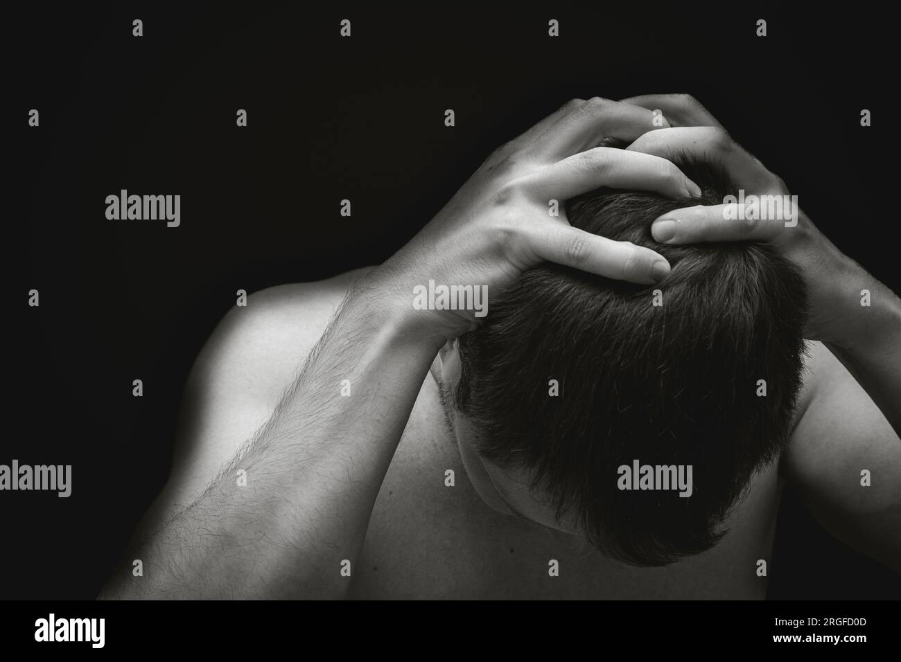 Man holding his head due to anxiety or depression Stock Photo - Alamy