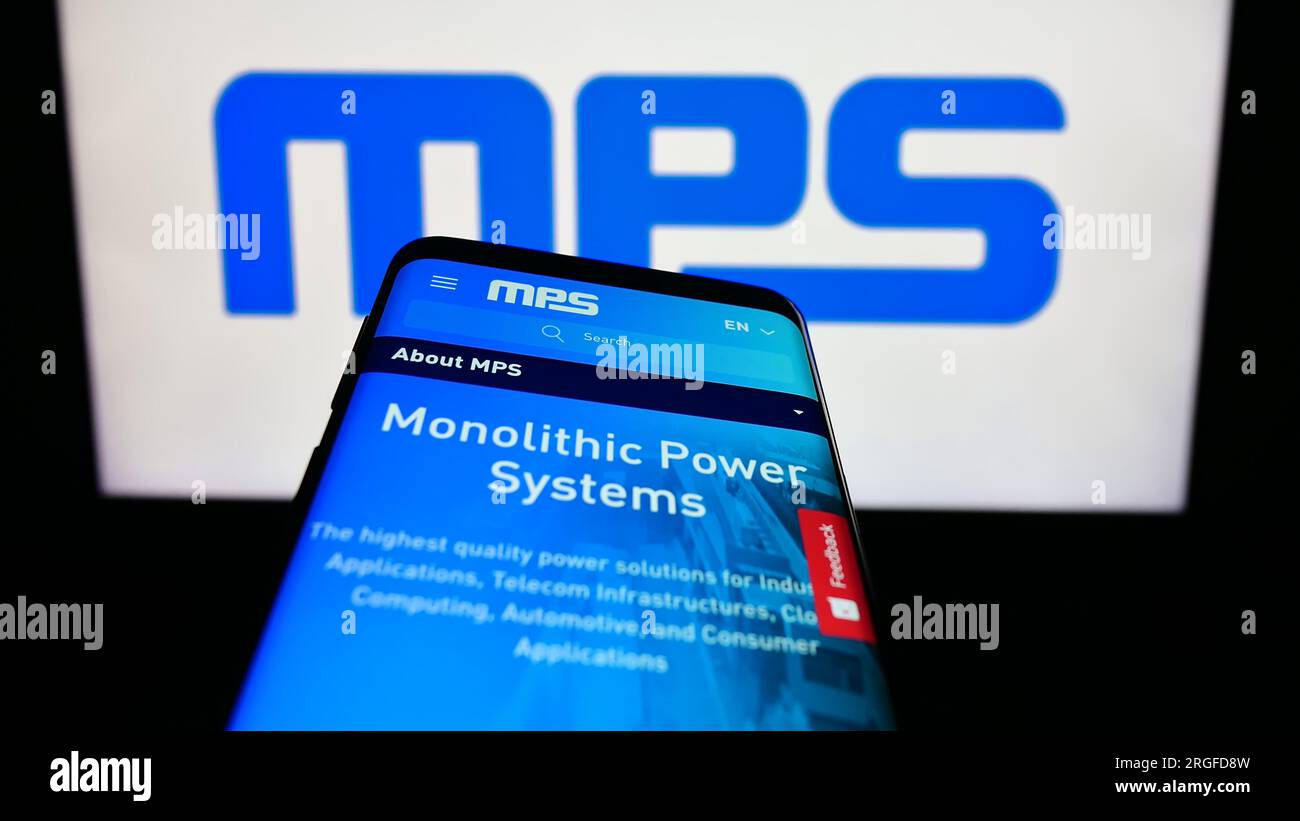 Mobile phone with website of US company Monolithic Power Systems Inc. (MPS) on screen in front of logo. Focus on top-left of phone display. Stock Photo