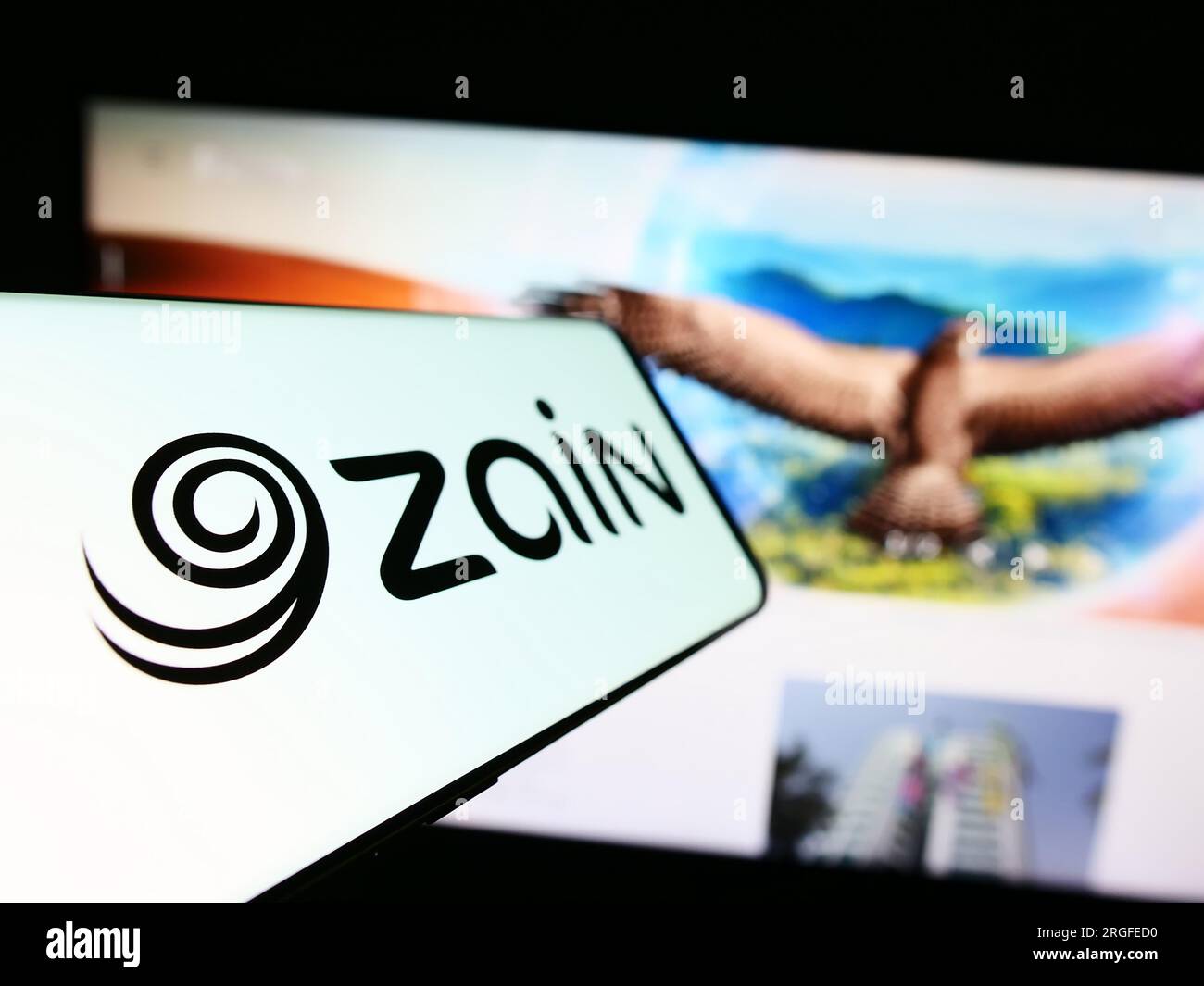 Smartphone with logo of Mobile Telecommunications Company K.S.C.P. (Zain)  on screen in front of business website. Focus on left of phone display  Stock Photo - Alamy