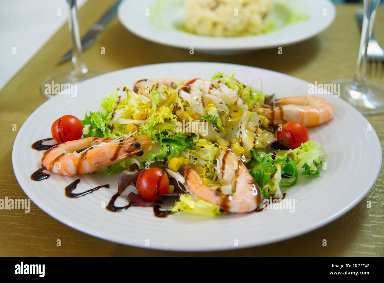 Salad made of shrimps, lettuce, cherry tomatoes and Modena vinegar. Stock Photo