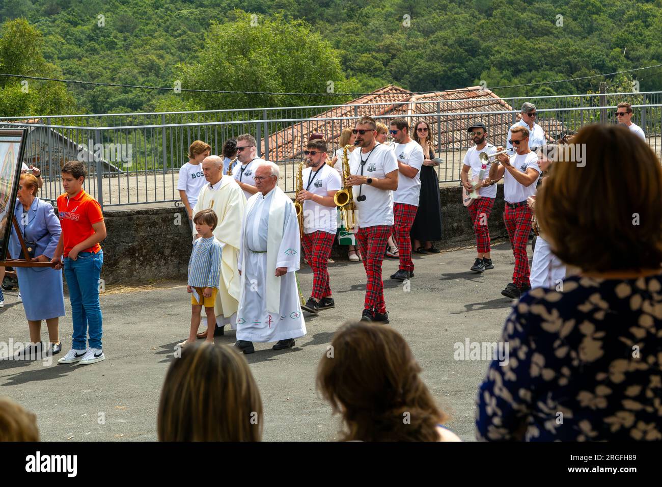 Village fiesta musicians and priests procession, Rubillon, Ourense province, Galicia, Spain Stock Photo
