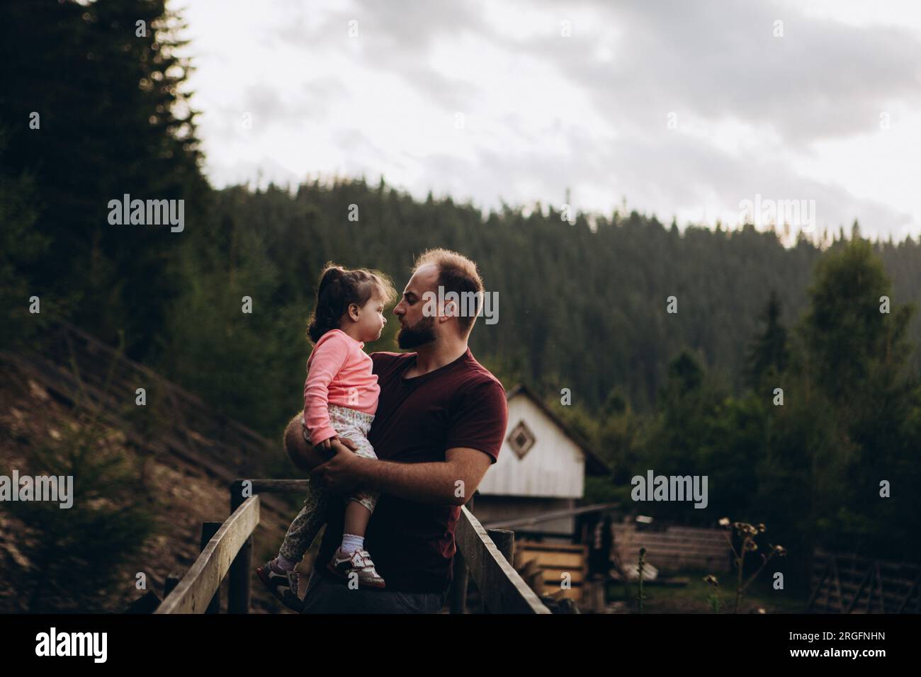 Happy father and daughter relaxing in pine forest Stock Photo - Alamy