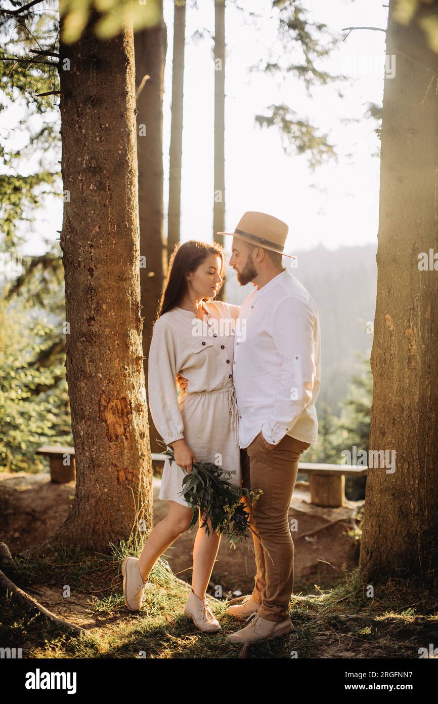 Young couple in love in sunny forest Stock Photo