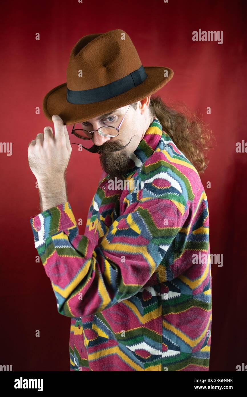 Vintage Hipster man with hat and mustache posing confident with colored ...