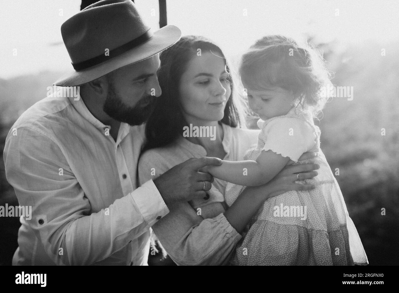 Happy family with little daughter outdoors. Black and white Stock Photo