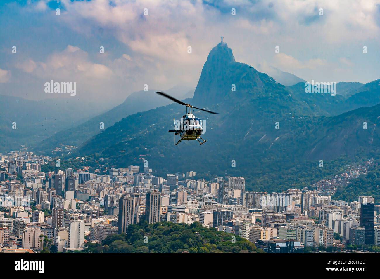 Panoramic view of the city and beaches from the observation deck on Sugarloaf Mountain in Rio de Janeiro with helicopter in flight during the day Stock Photo
