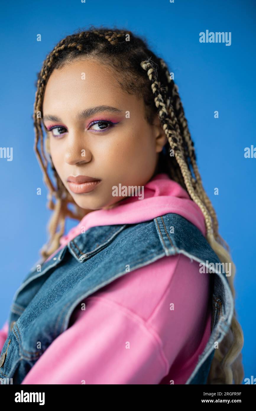 attractive african american woman with dreadlocks looking at camera on ...
