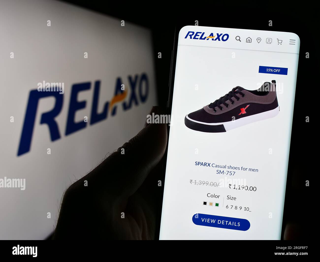 Person holding smartphone with logo of shoe company Birkenstock Group B.V.  Co. KG on screen in front of website. Focus on phone display Stock Photo -  Alamy