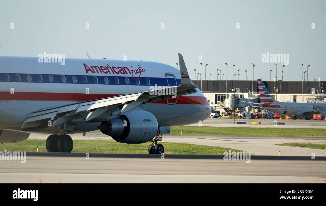 American Eagle regional jet with retro livery taxies on the runway after landing at Chicago O'Hare International Airport. Stock Photo
