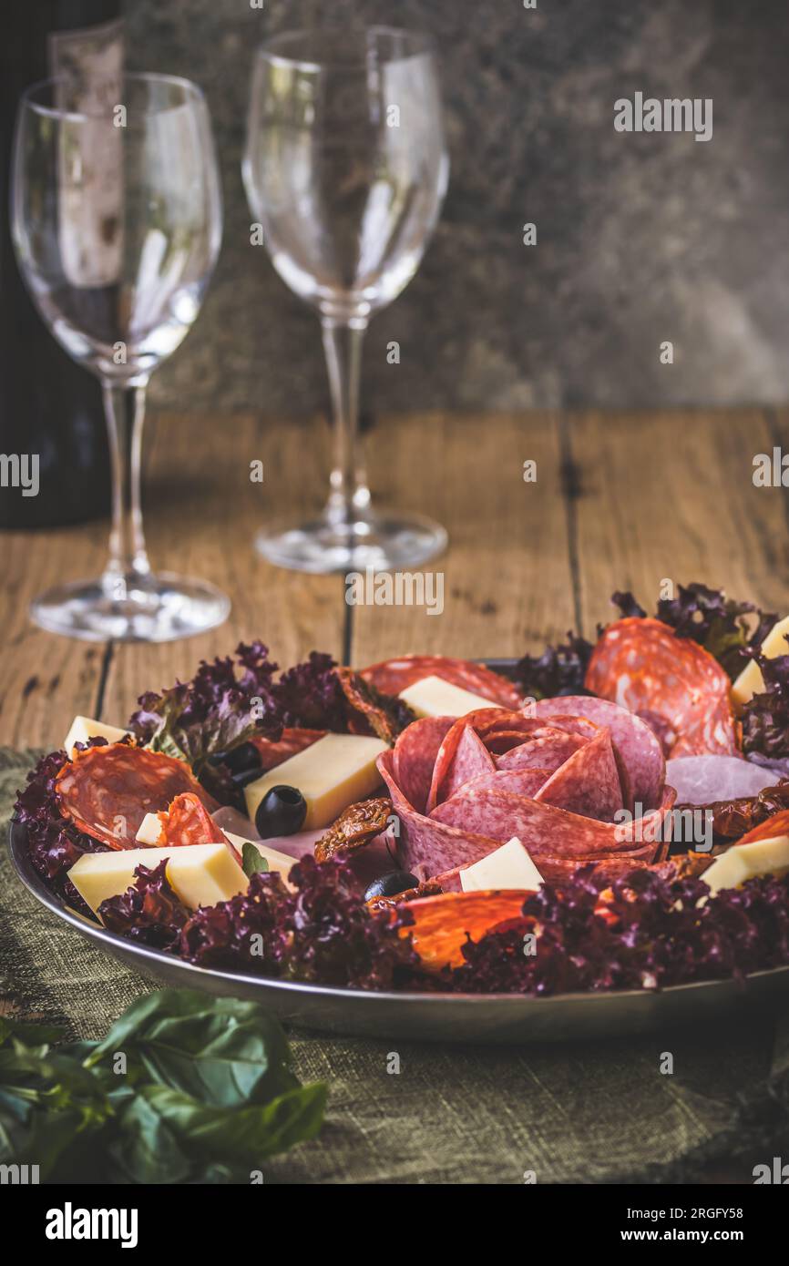 Traditional Italian antipasti on a plate served with olives. Aperitif, lunch or buffet in a