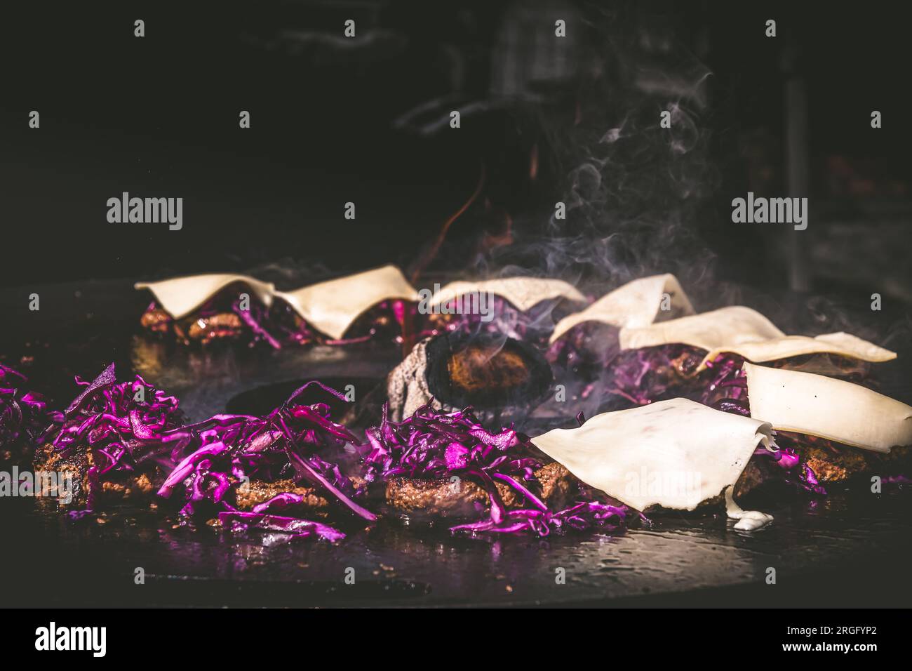 Preparing juicy beef hamburger patties with red cabbage and cheese. BBQ