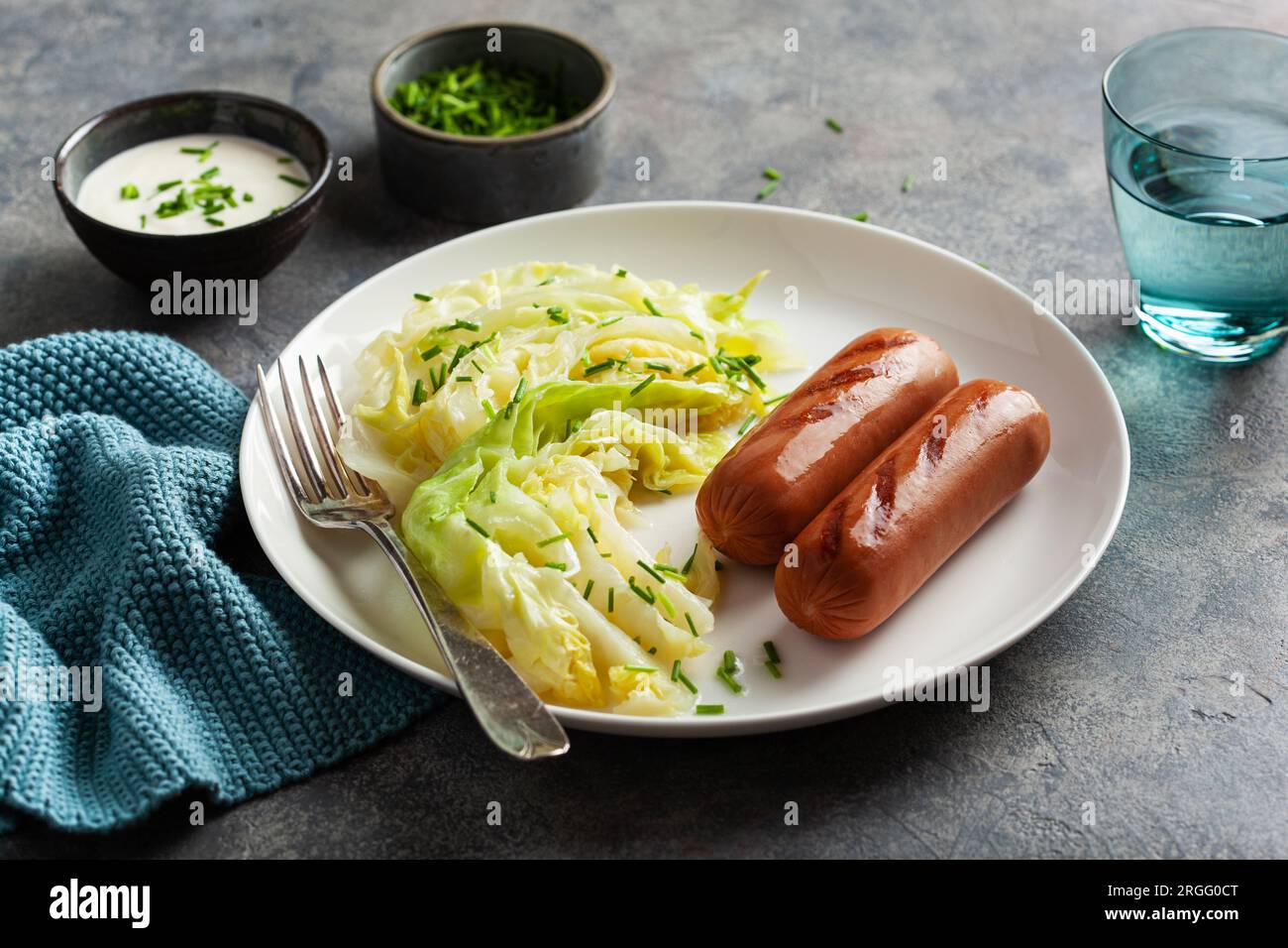 grilled sausages and stewed steamed cabbage with butter, healthy keto meal Stock Photo