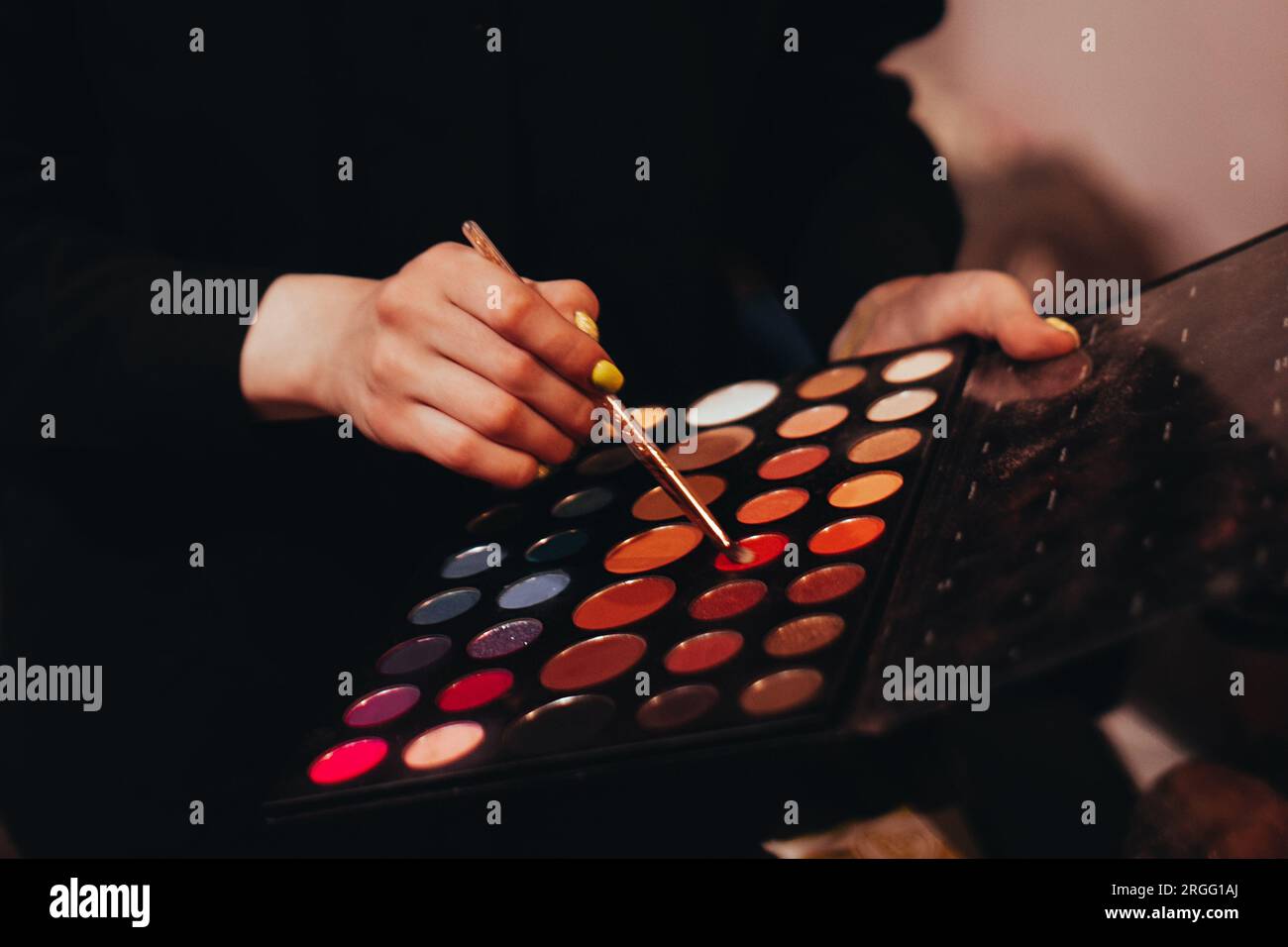 Female hands holding decorative brush and color palette for makeup Stock Photo
