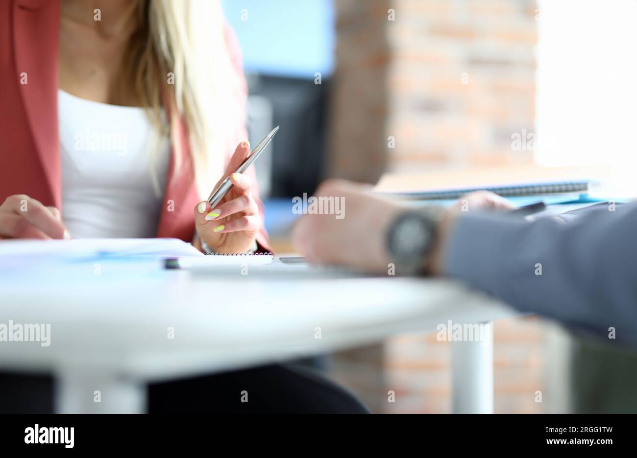 Female hand lay on table and hold pen close up Stock Photo - Alamy