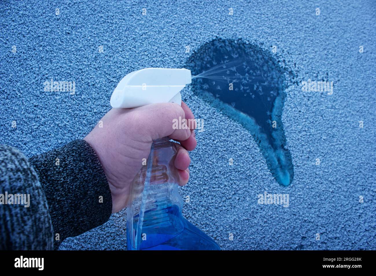 Removal ice from automobile windshield. Hand with liquid spray for car  window defrost in winter season Stock Photo - Alamy