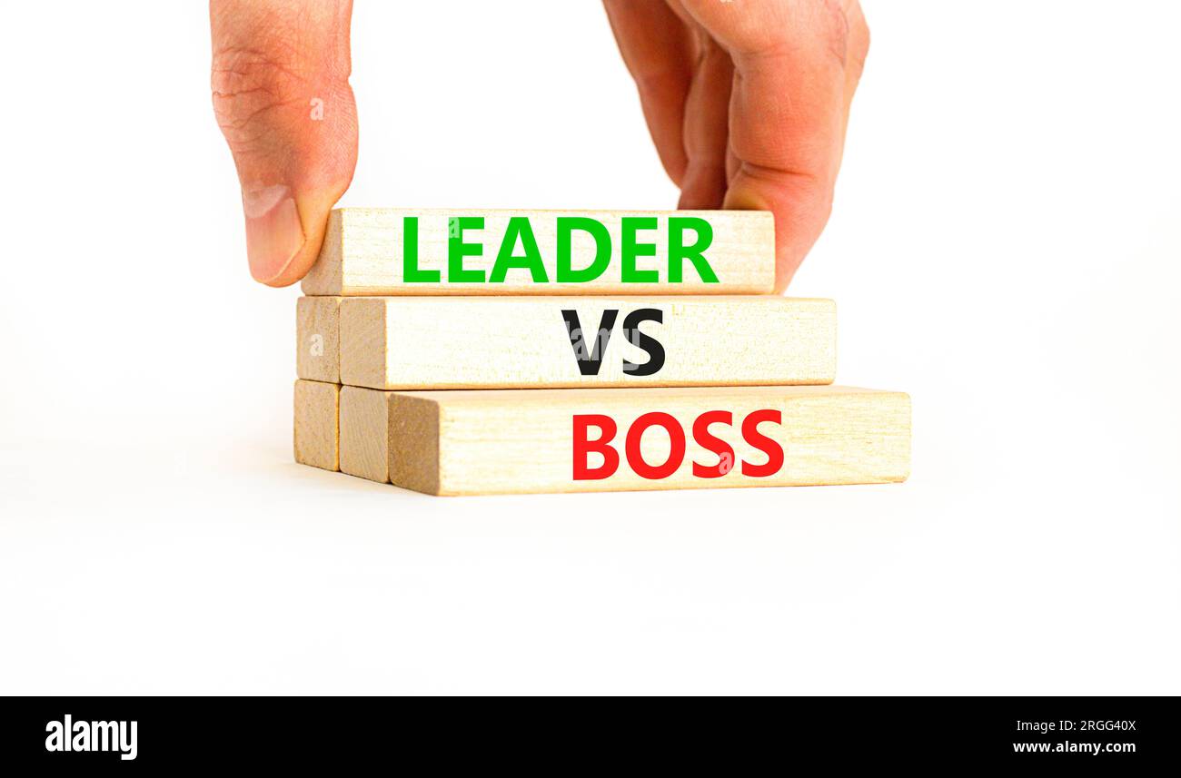 Boss vs leader symbol. Concept words Boss vs versus leader on wooden block.  Beautiful white table white background. Businessman hand. Business motivat  Stock Photo - Alamy