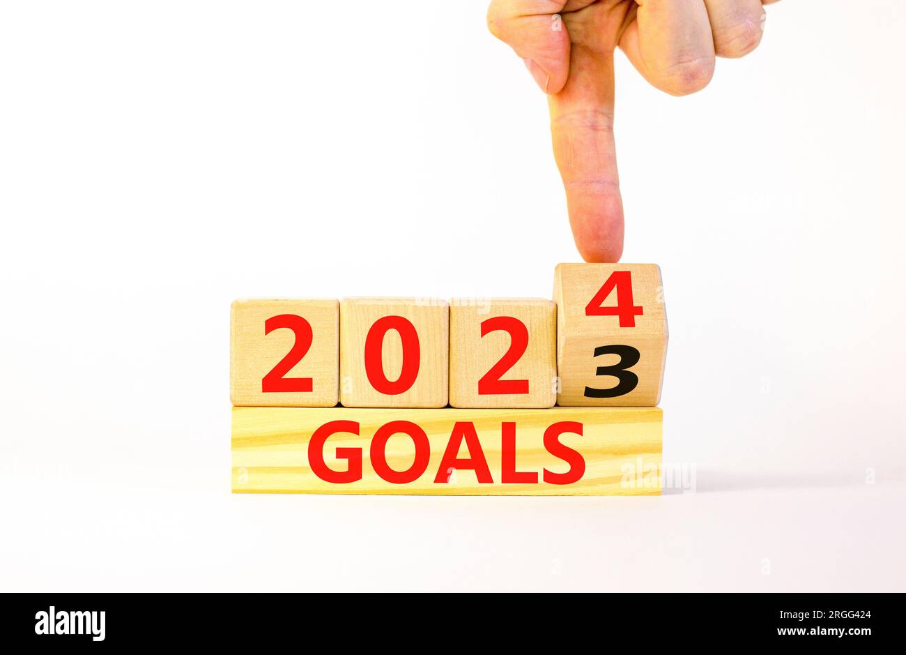 Planning 2024 goals new year symbol. Businessman turns a wooden cube