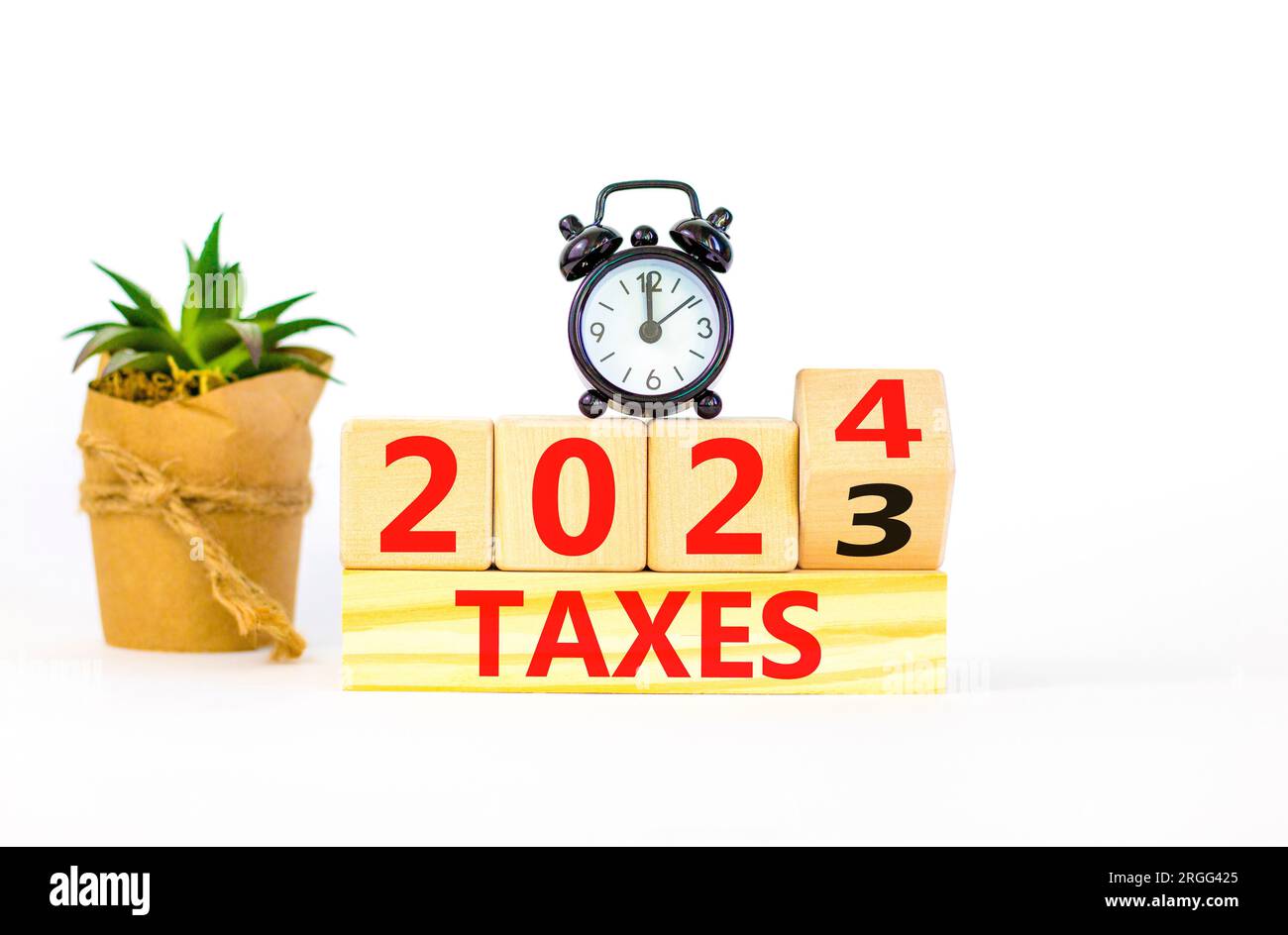 2024 taxes new year symbol. Businessman turns a wooden cube and changes