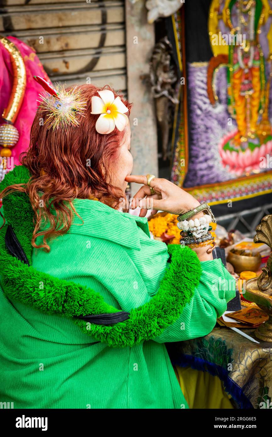 A Thai fortune teller sits with a young Thai girl on Sala Daeng Rd