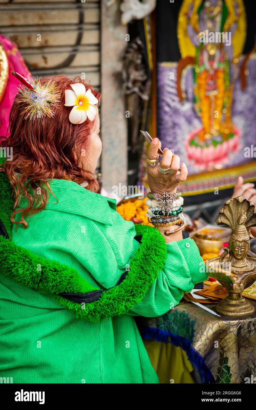A Thai fortune teller sits with a young Thai girl on Sala Daeng Rd
