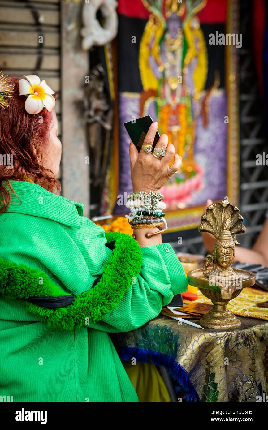 A Thai fortune teller sits with a young Thai girl on Sala Daeng Rd