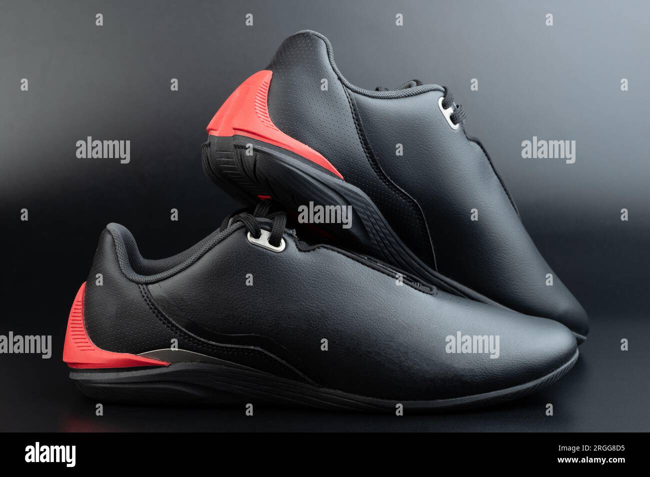 Black pair motosport shoes with flat sole isolated on studio background Stock Photo