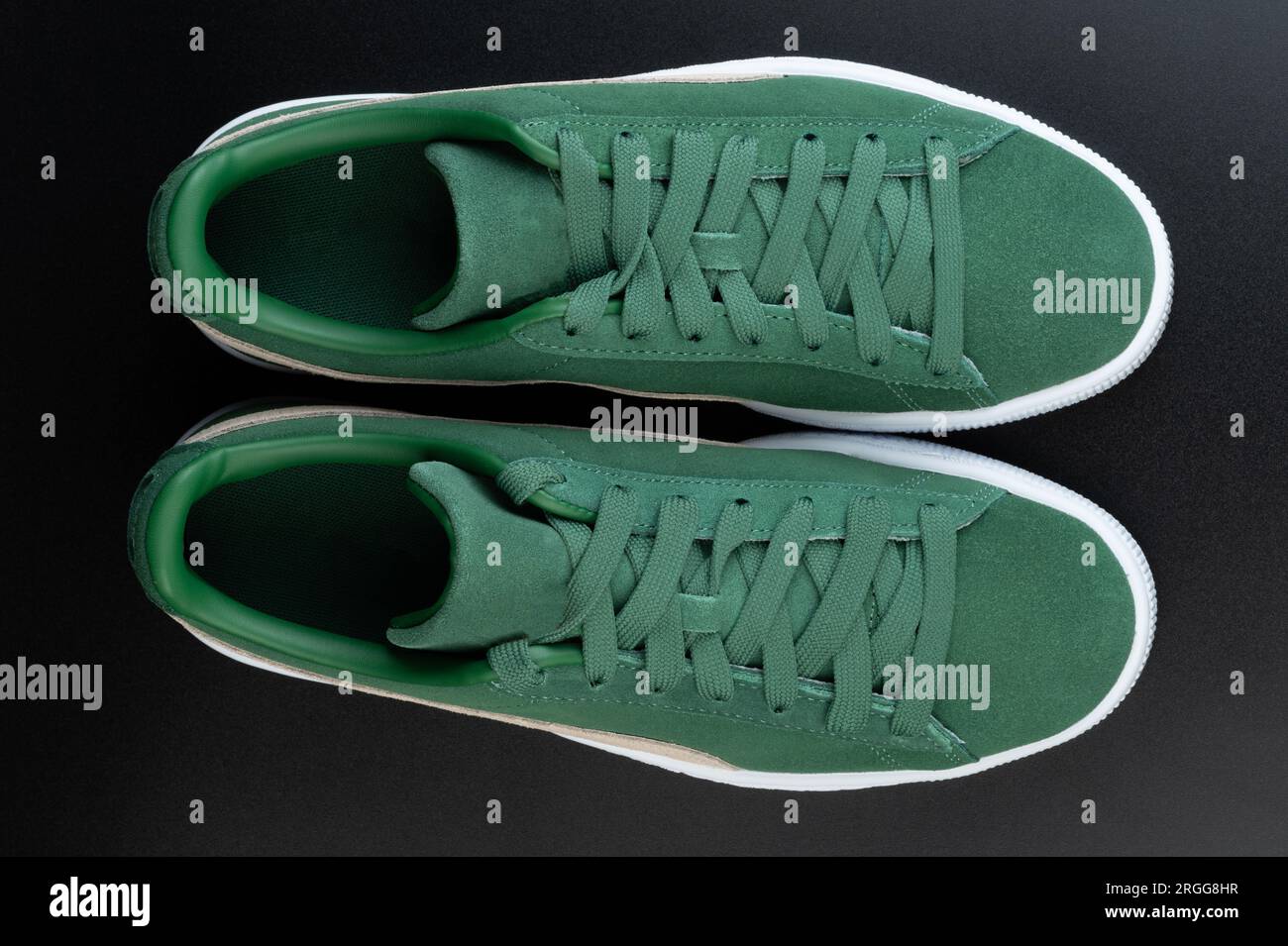Pair of green sneakers with laces above top view isolated on black studio background Stock Photo