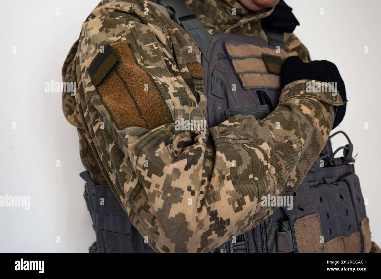 Ukrainian soldier in uniform with arm in glove near heart. A banner of ...