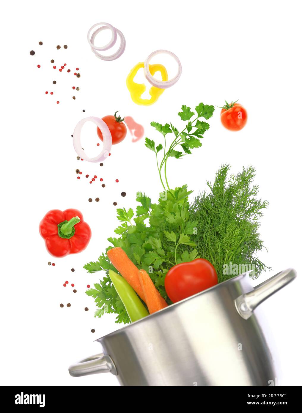 Fresh vegetables falling into a cooking pot isolated on white transparent background Stock Photo