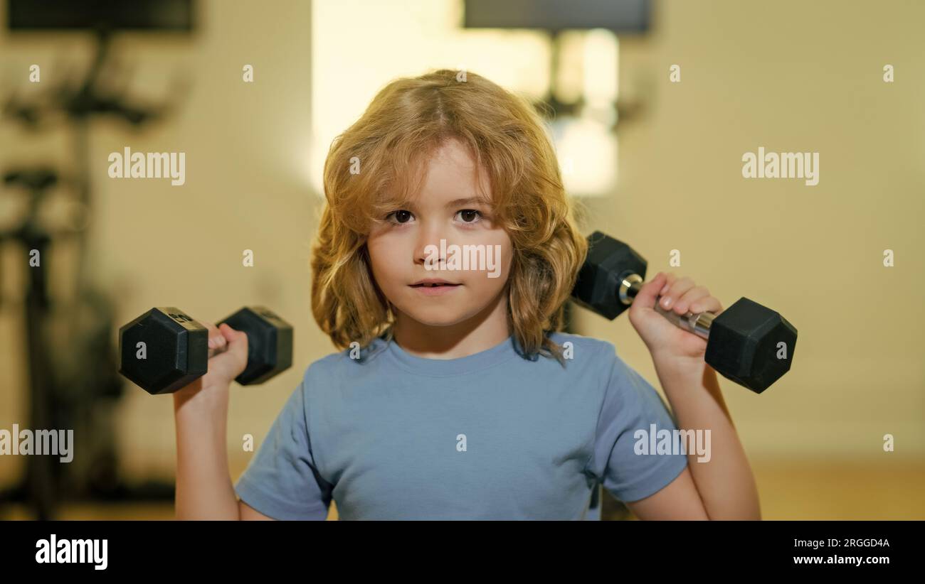 Work Out Kid Kid raising a dumbbell. Cute child training with dumbbells. Kids ...
