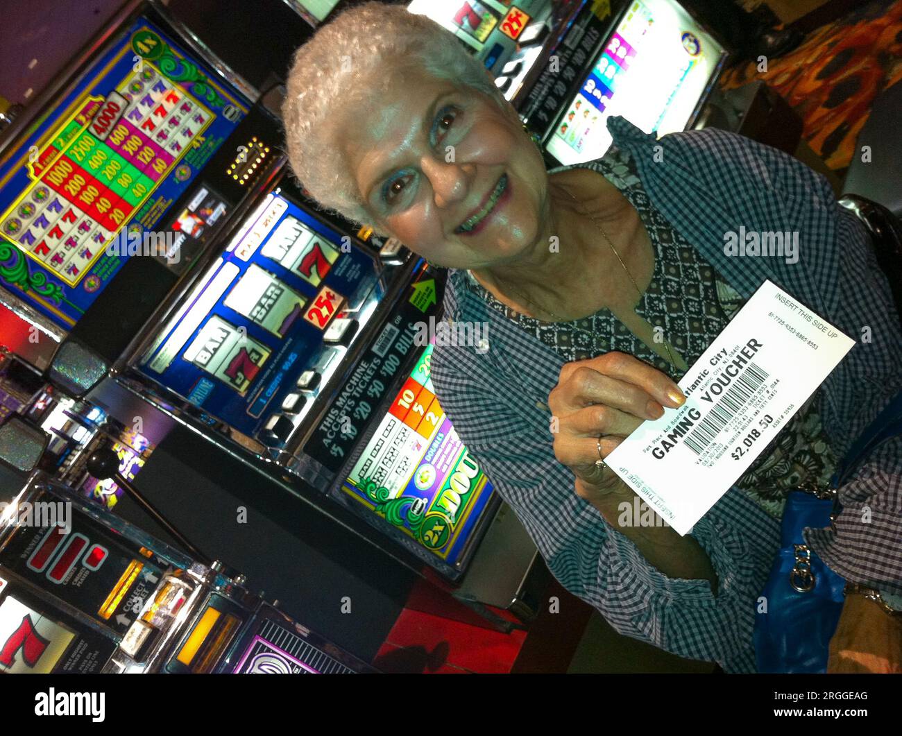 Proud winner shows her gaming voucher. Stock Photo