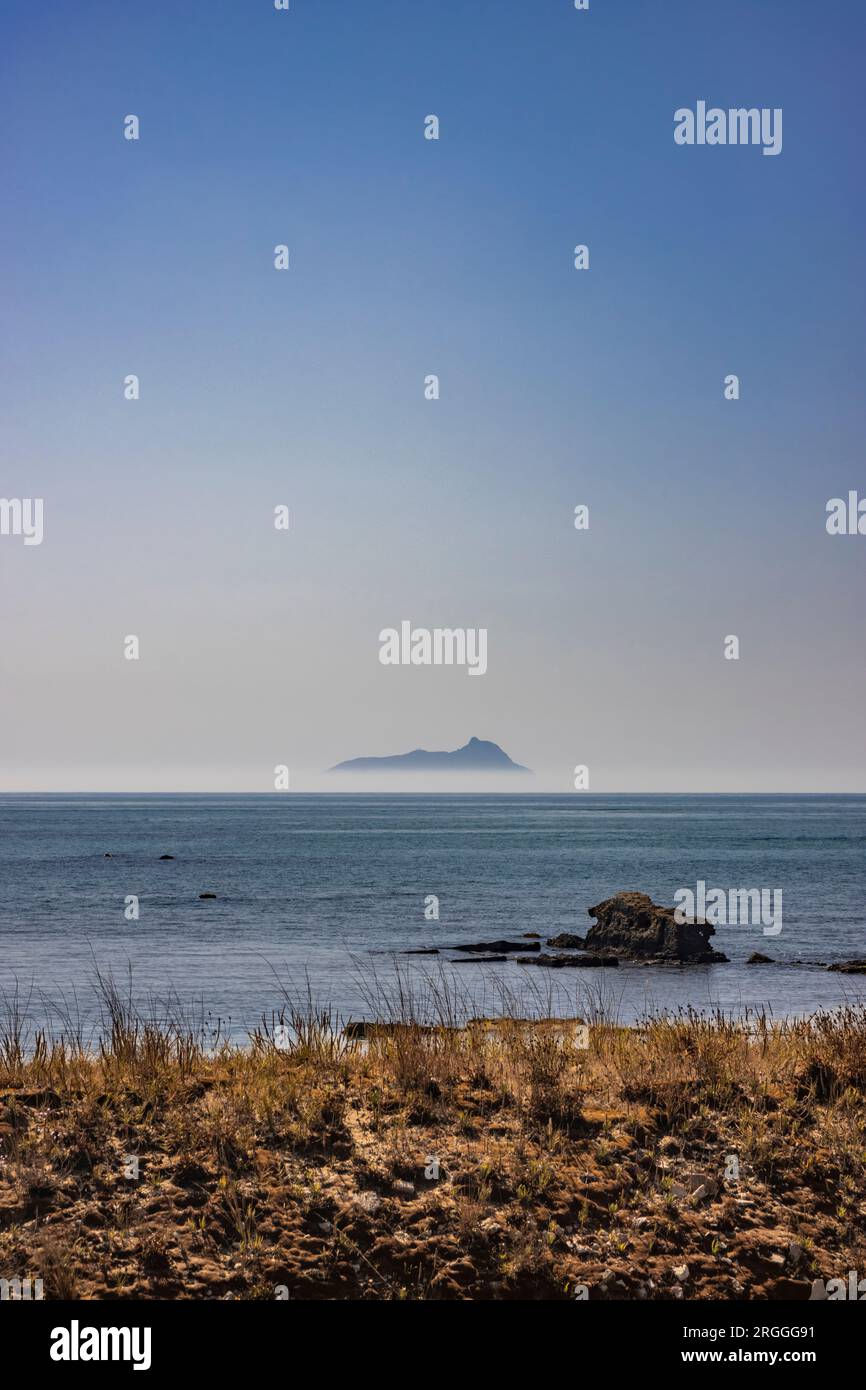 Ponza, Italy. The silhouette of the island emerging from the fog, seen from the Lazio coast in the distance. Stock Photo