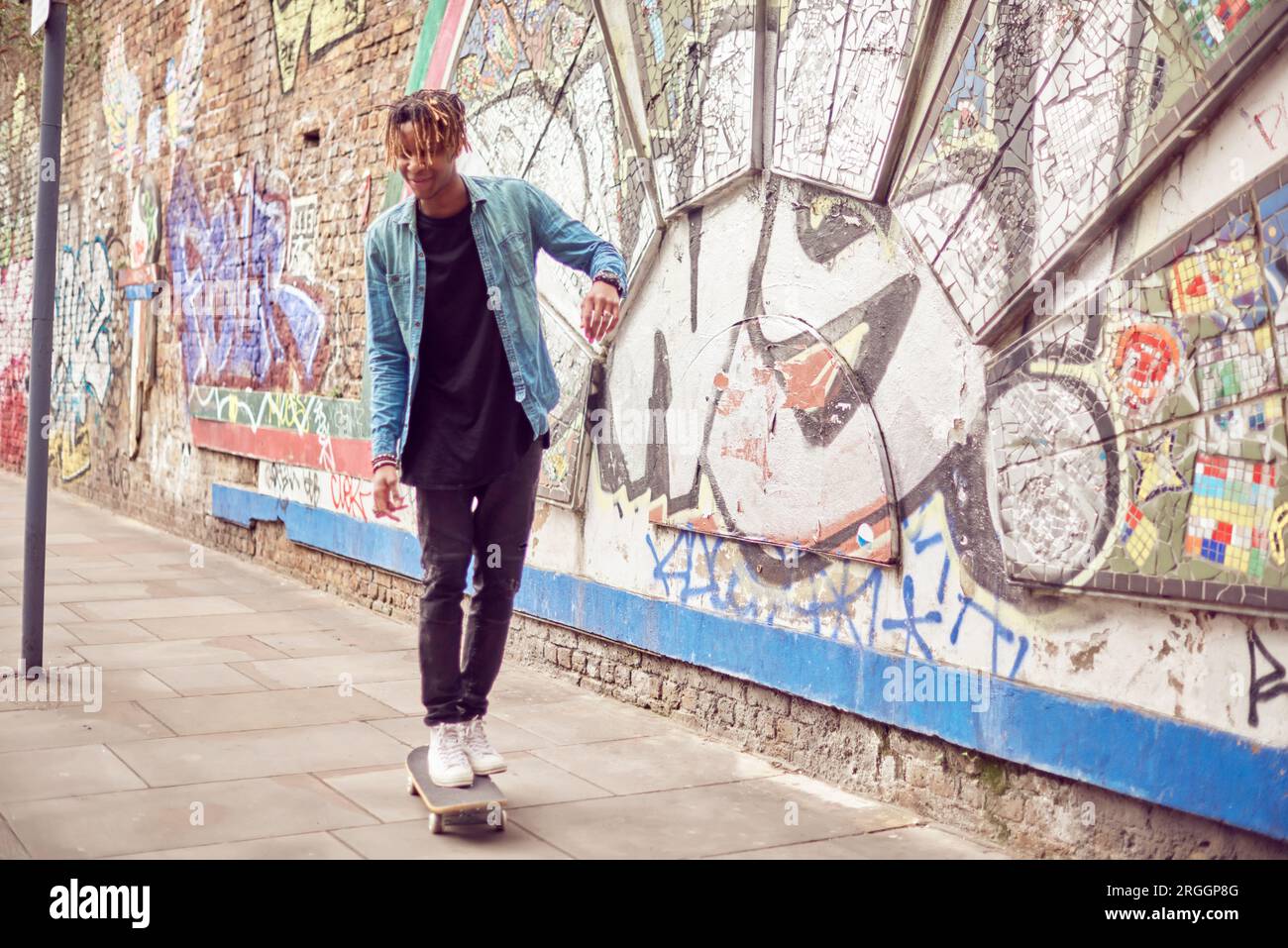Teenage boy using skateboard Stock Photo - Alamy