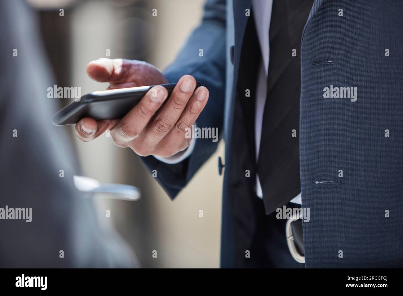 Hand of businessman using smartphone Stock Photo