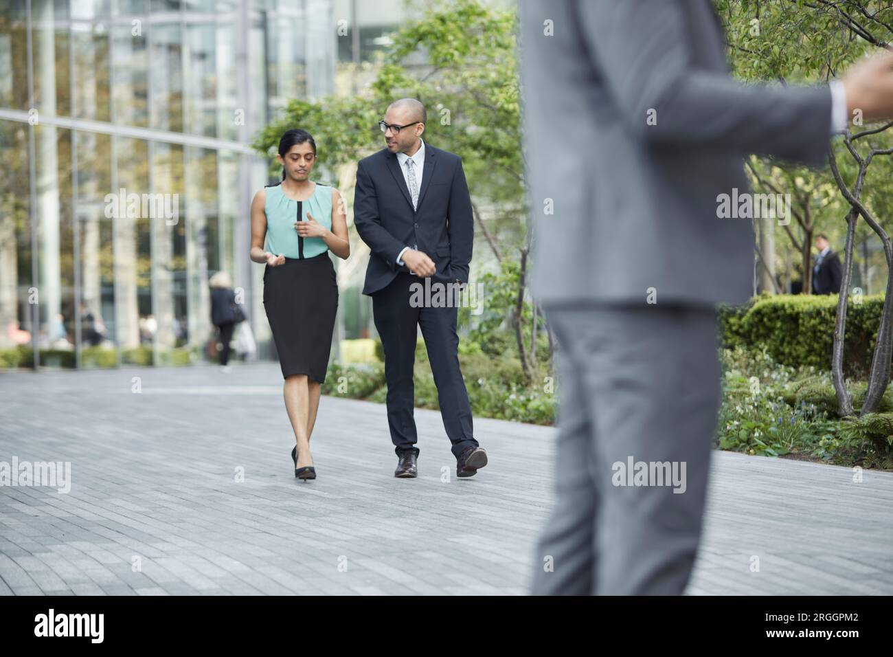 Businesspeople walking together at business park Stock Photo - Alamy