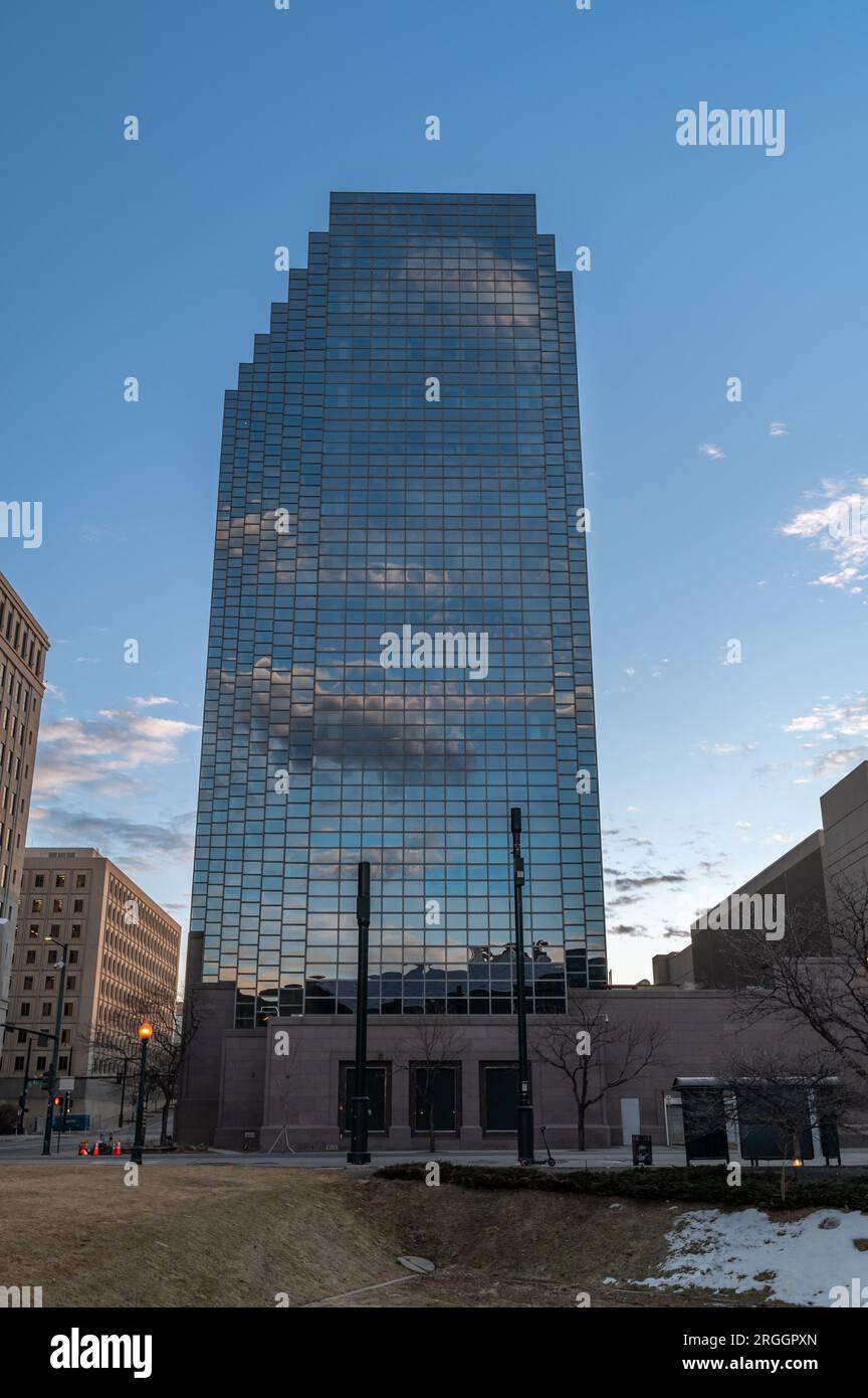 Denver, Colorado - February 12 2023: A view of the mirrored reflection of a downtown highrise in the moments before the sun rises in the eastern sky a Stock Photo